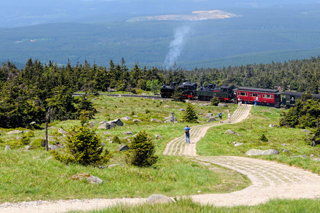 BROCKEN MOUNTAIN, SAXONY-ANHALT / GERMANY May 26 2012: historical locomotive is going up high to Brocken peak with tourists. Brocken is part of Harz National Park.のeditorial素材