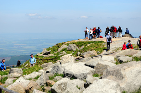 BROCKEN MOUNTAIN, SAXONY-ANHALT / GERMANY May 26 2012: People visiting Brocken Mountain National Park at resin (Germany). In front a group of people hiking on peak. in background a wonderfull view over the resin mountain area.のeditorial素材