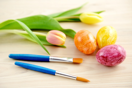 easter eggs with tulips and paintbrushの写真素材