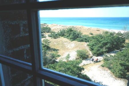looking through window of lighthouse at Western Pomerania Lagoon Area National Park with its beach,...