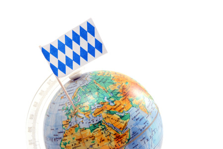 globe with bavarian flag stucking on bavaria. copy space. white isolated backgroundの写真素材