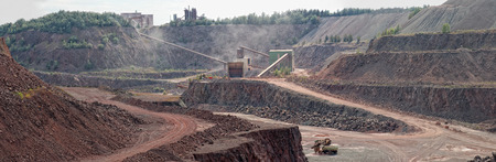 view into a quarry mine of porphyry rock. Stonecrusher and conveyor belt. panoramic image of 5 separate images.の写真素材