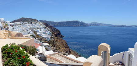 Ia, Santorini / GREECE May 15 2017: Cityscape of Ia, town at Santorini Isle (Greece). people walking along the promenade. View into Caldera of Volcano. made of 6 imagesのeditorial素材