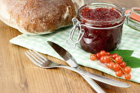 Homemade red currant jam and bread for breakfastの写真素材