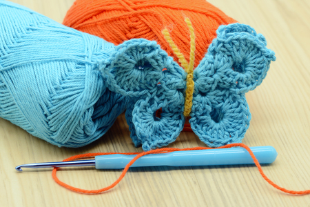 crocheting blue butterfly with crochet hook and woolの写真素材