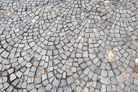 round urban pavement granite stones on a footpath. texture background.の写真素材