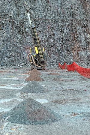 Driller in a Porphyry mine quarry. industrial tools.