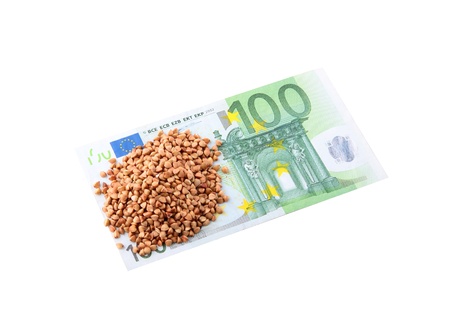 100 Euro and buckwheat groats isolated on a white backgroundの写真素材
