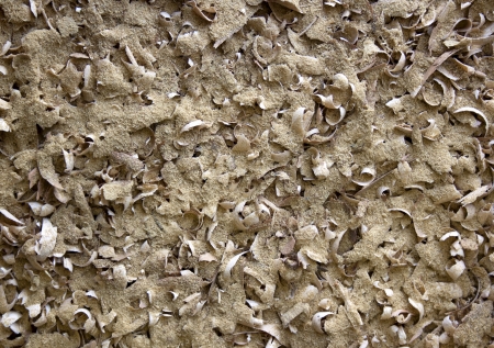 A flat view of a dense collection of various wood shavings texture with finer sawdust inbetweenの写真素材