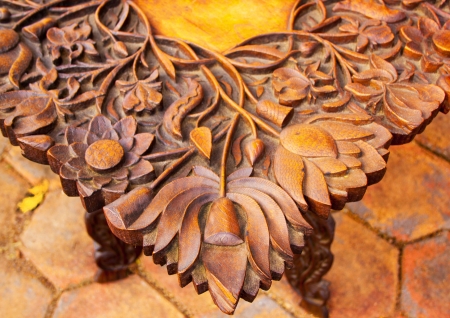 Corner of intricate carved wooden tableの写真素材
