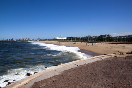 View of Fishermen On Blue Lagoon Beach Against City Skyline in Durban South Africaのeditorial素材