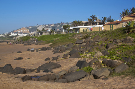 DURBAN, SOUTH AFRICA - APRIL 19, 2014: Adults and children on the beach and promenade walkway on Ballito beach in Durban north coast South Africaのeditorial素材