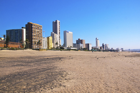 stretch of beach flanked by hotels and residential apartmentsのeditorial素材