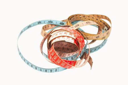 three coiled tape measues in blue red and yellow