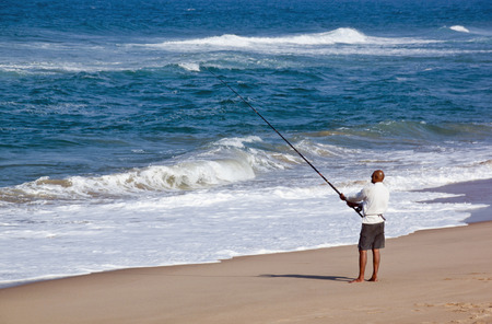 DURBAN, SOUTH AFRICA - JULY 2, 2014: Unknown fisherman on Blue Lagoon  beach in Durban, South Africaのeditorial素材