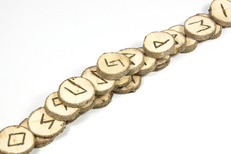 handmade wooden runes piled atop one anotherの写真素材