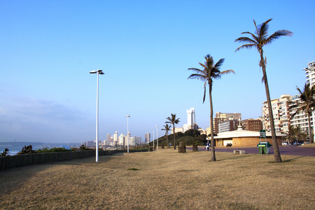 DURBAN, SOUTH AFRICA - JULY 23, 2014: Four people enjoy a quiet early morning on Golden Mile beach front in Durban, South Africaのeditorial素材