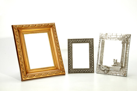 three isolated ornate empty picture frames on whiteの写真素材
