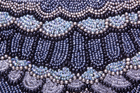 closeup of embroided pattern in beads on scatter cushionの写真素材