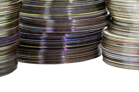 closeup three piles of colorful compact discs