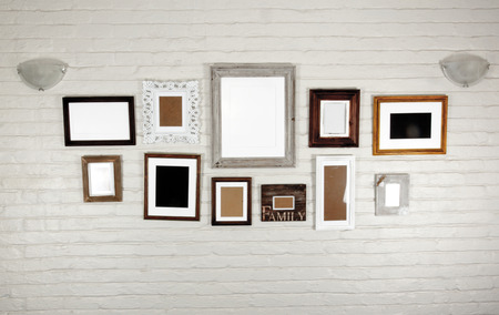 empty frames and lamps on white bagged wall