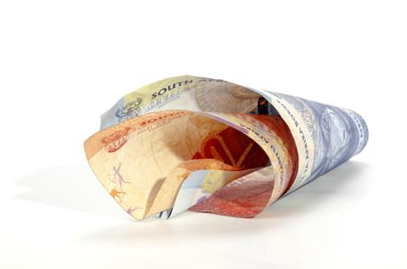 Two isolated coiled South African Bank Notes on white