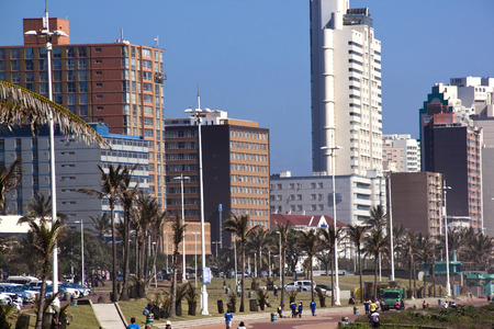 DURBAN; SOUTH AFRICA - DECEMBER 4; 2014 : Many unknown people amongst commercial and residential buildings along the "Golden Mile" beach front in Durban, South Africaのeditorial素材