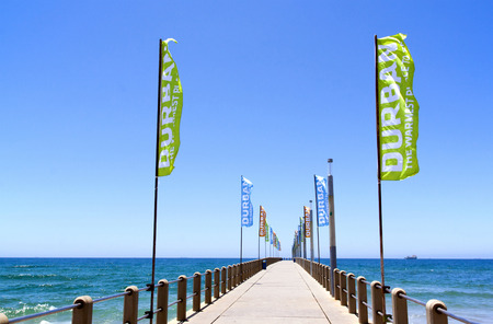 DURBAN, SOUTH AFRICA - DECEMBER 18, 2014: Promotional banners on empty pier on North Beach in Durban, South Africaのeditorial素材