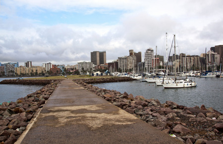 DURBAN, SOUTH AFRICA - JANUARY 30, 2015: Rainy early morning view of empty pier at yacht mole against City Skyline in Durban, South Africaのeditorial素材