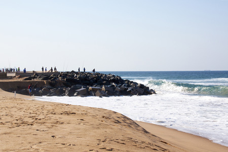 DURBAN, SOUTH AFRICA - JUNE 12, 2015: many unknown fishermen fish at Blue Lagoon beach in Durban, South Africaのeditorial素材