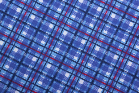 Closeup angled view of colorful blue square patterns and textures on blue fabric background