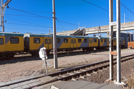 DURBAN, SOUTH AFRICA - JUNE 19, 2016: Yellow metro train passing under bridge heading toward city centre in Durban, South Africaのeditorial素材