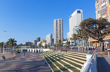 DURBAN, SOUTH AFRICA - AUGUST 25, 2016: Many unknown people on quiet early morning promenade on Golden Mile beach front in Durban, South Africaのeditorial素材