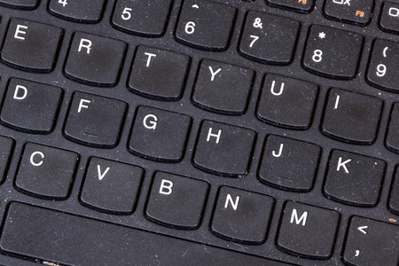 Close up of grimy black dirty dusty grungy neglected  laptop keyboard
