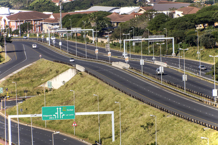  Morning landscape close up of empty M41 freeway with on and off ramps passing through urban...