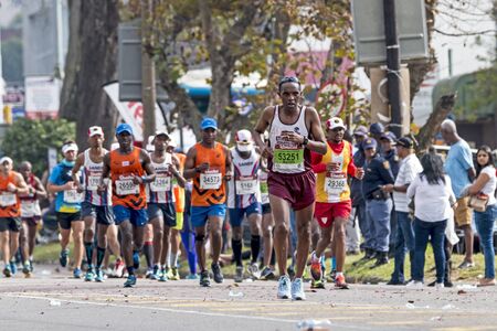 PINETOWN, DURBAN, SOUTH AFRICA - JUNE 10, 2018: Midday many spectators and unknownn runners passing through Pinetown whilst competing in the 2018 Comrades marathon between Pietermaritzburg and Durban in South Africaのeditorial素材