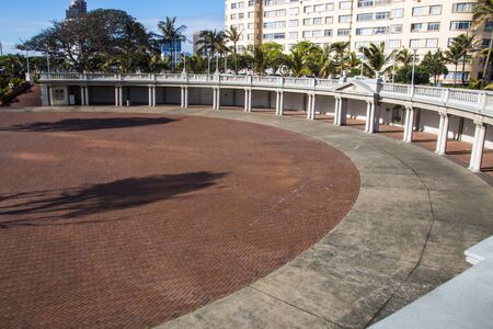 Sunken paved and cement amphitheatre on durban beachfront in front of hotelsの写真素材