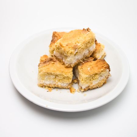 closeup of pieces of coconut cake isolated on white backgroundの写真素材