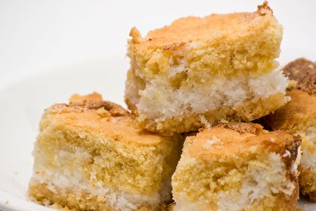 closeup of pieces of coconut cake isolated on white backgroundの写真素材