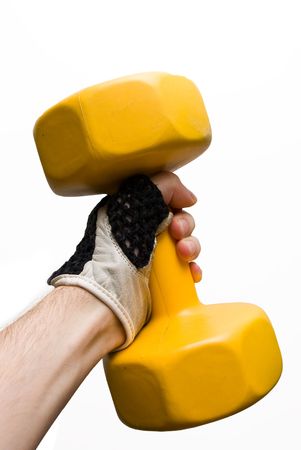 yellow dumbbell in a male hand isolated on white backgroundの写真素材
