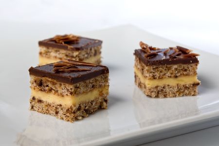 pieces of a chocolate cake on a plate in shallow depth of fieldの写真素材