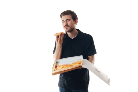 Young man eating pizza isolated on whiteの写真素材