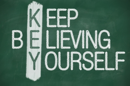 Acronym of KEY. Believe in yourself written in chalk on a blackboardの写真素材