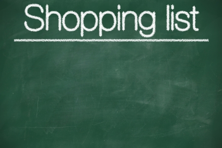 Shopping list written with white chalk on a blackboardの写真素材