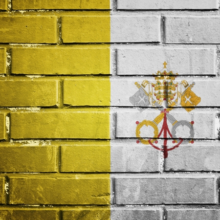 Vatican city flag on the brick wallの写真素材
