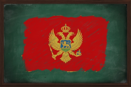 Montenegro flag painted with color chalk on old blackboardの写真素材