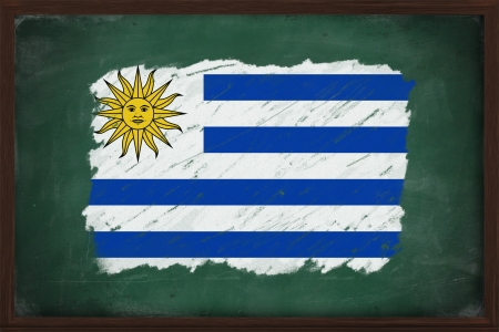 Uruguay flag painted with color chalk on old blackboardの写真素材