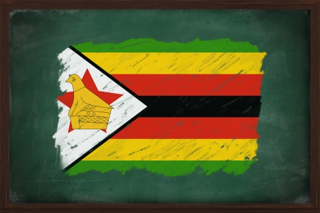 Zimbabwe flag painted with color chalk on old blackboardの写真素材
