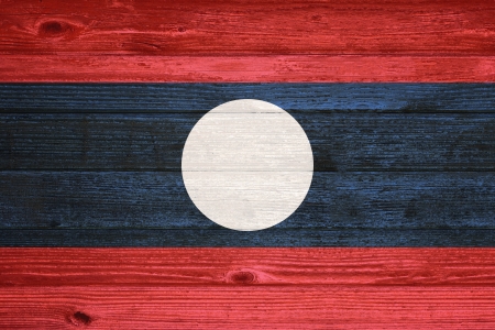 Laos Flag painted on old wood plank backgroundの写真素材