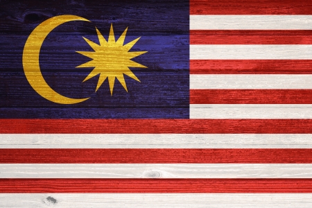 Malaysia Flag painted on old wood plank backgroundの写真素材